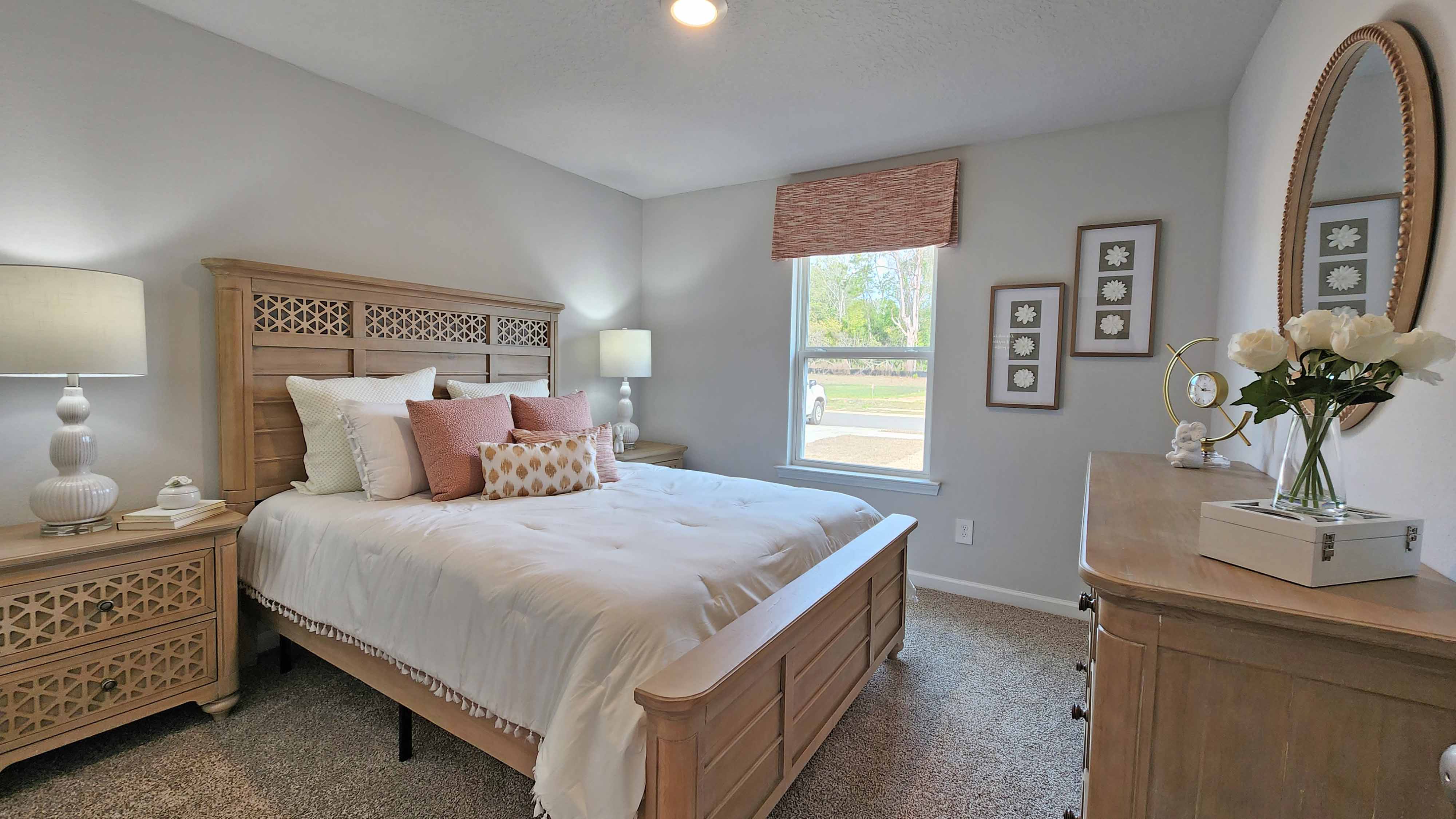 Guest room with neutral tones and queen bed space.