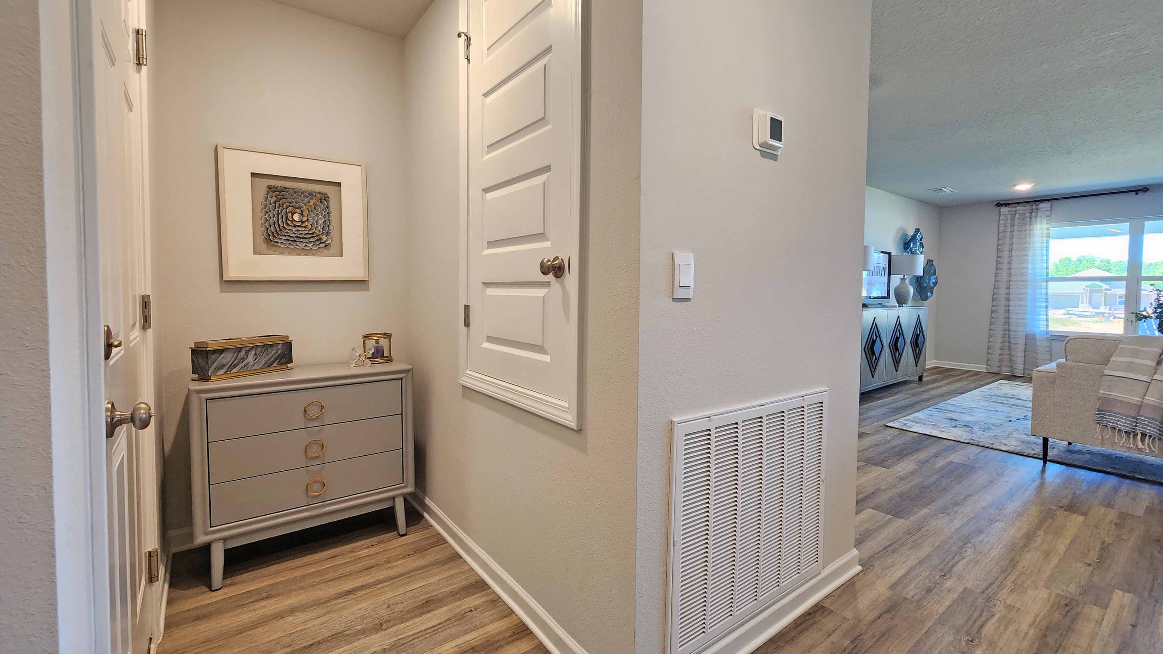 Hallway nook with air conditioning closet access.