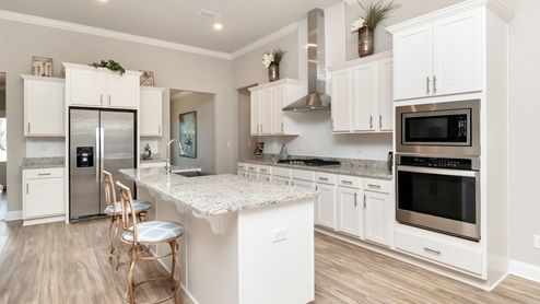 Kitchen view of the single standing island in the Dees Plantation model.