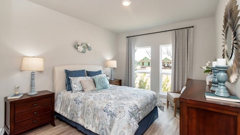 Beautifully decorated bedroom in the Kingston model at Dees Plantation.