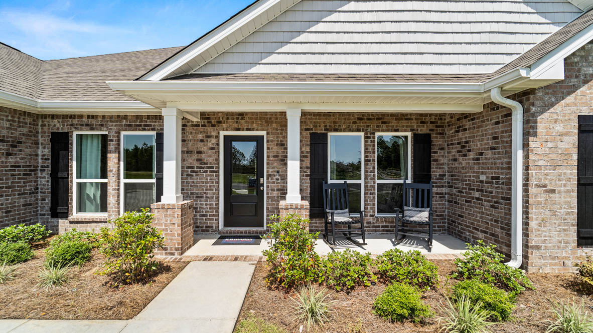 Covered front porch in a Kingston plan with beautiful landscaping.