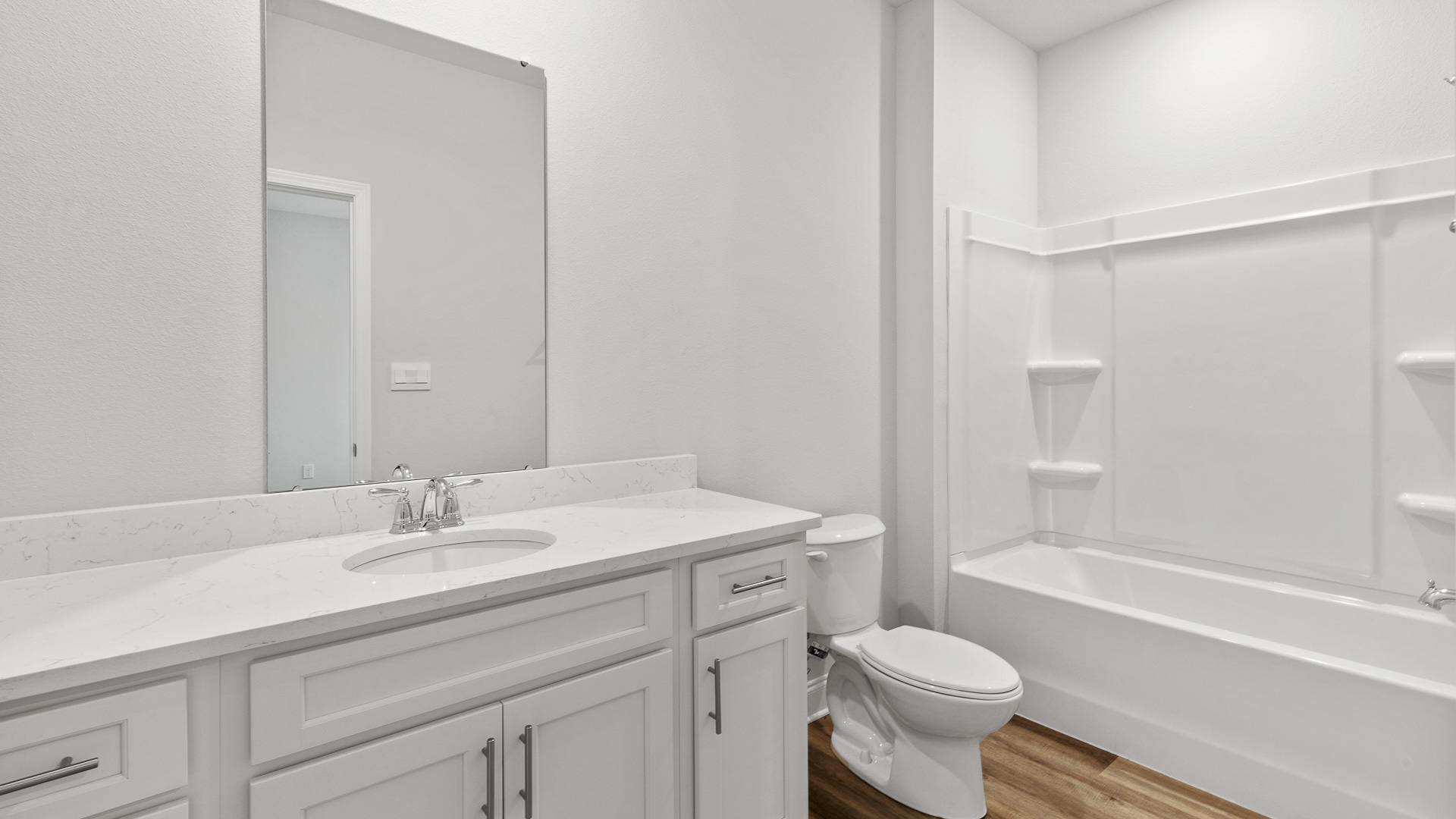 Guest bath in the Kingston with white cabinets and white quartz countertops.