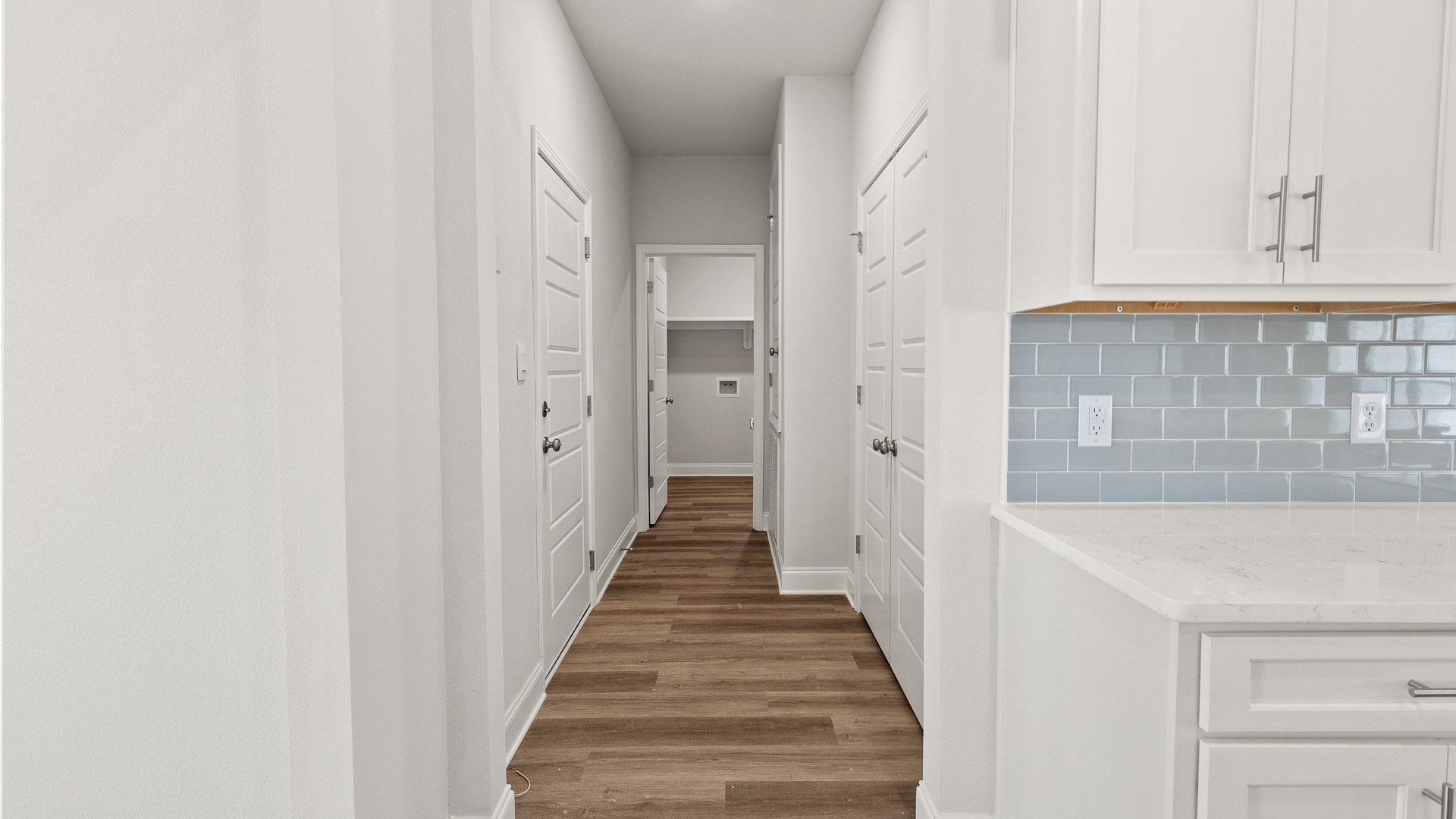 White kitchen with pale gray backsplash tile in Mobile County.