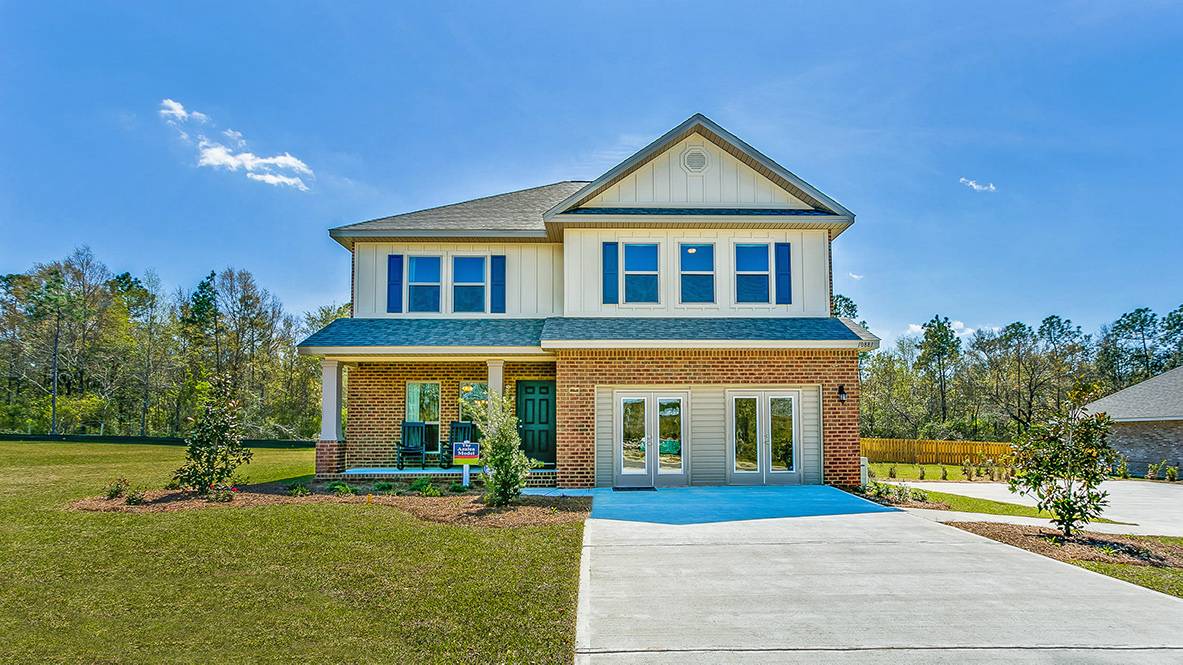 Two-story home exterior with a covered front porch and 2-car garage.