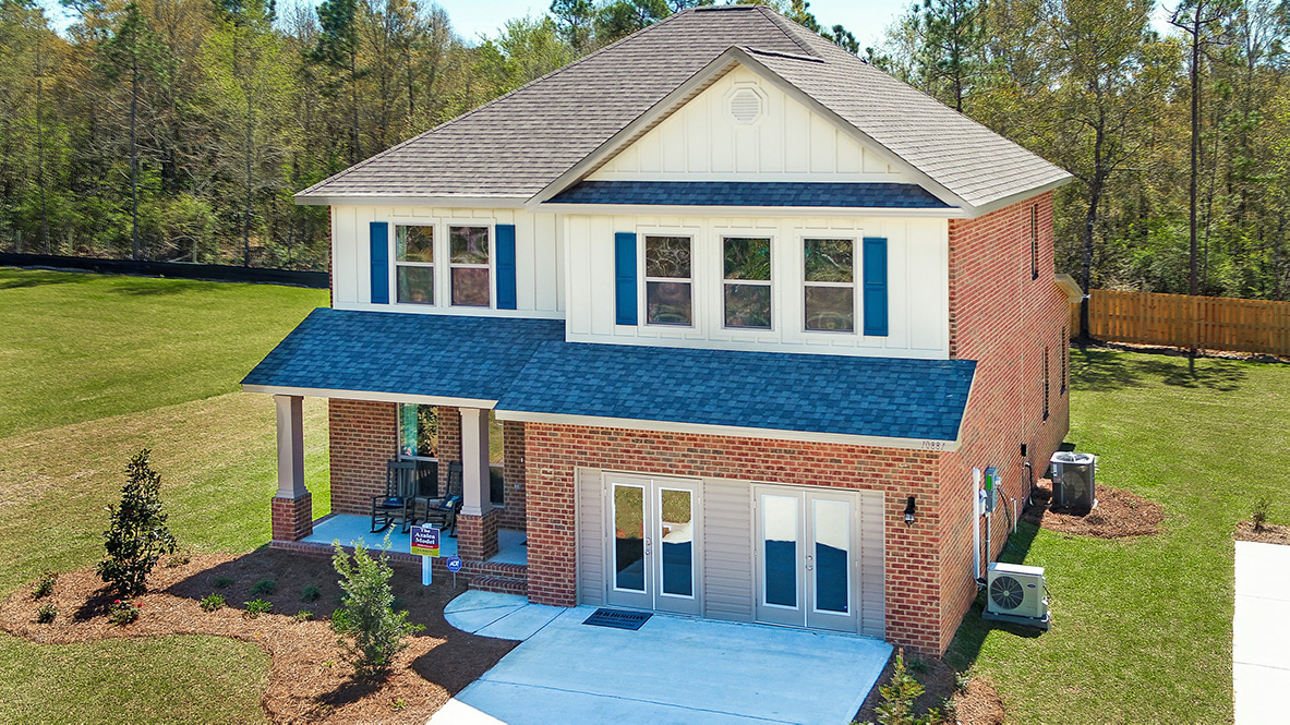Two-story home exterior with a covered front porch and 2-car garage.