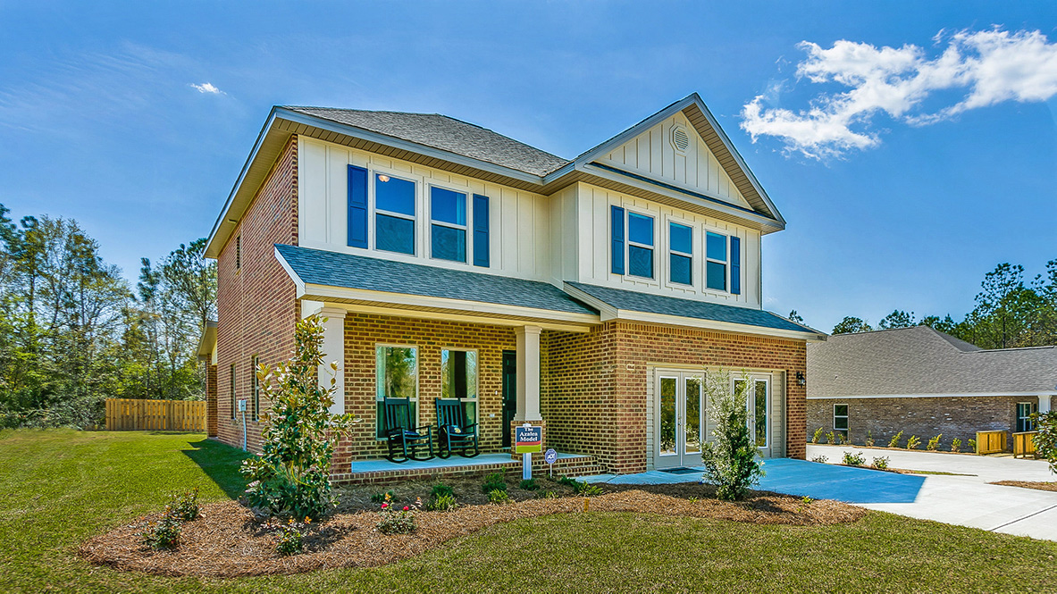 Two-story home exterior with a covered front porch and 2-car garage.