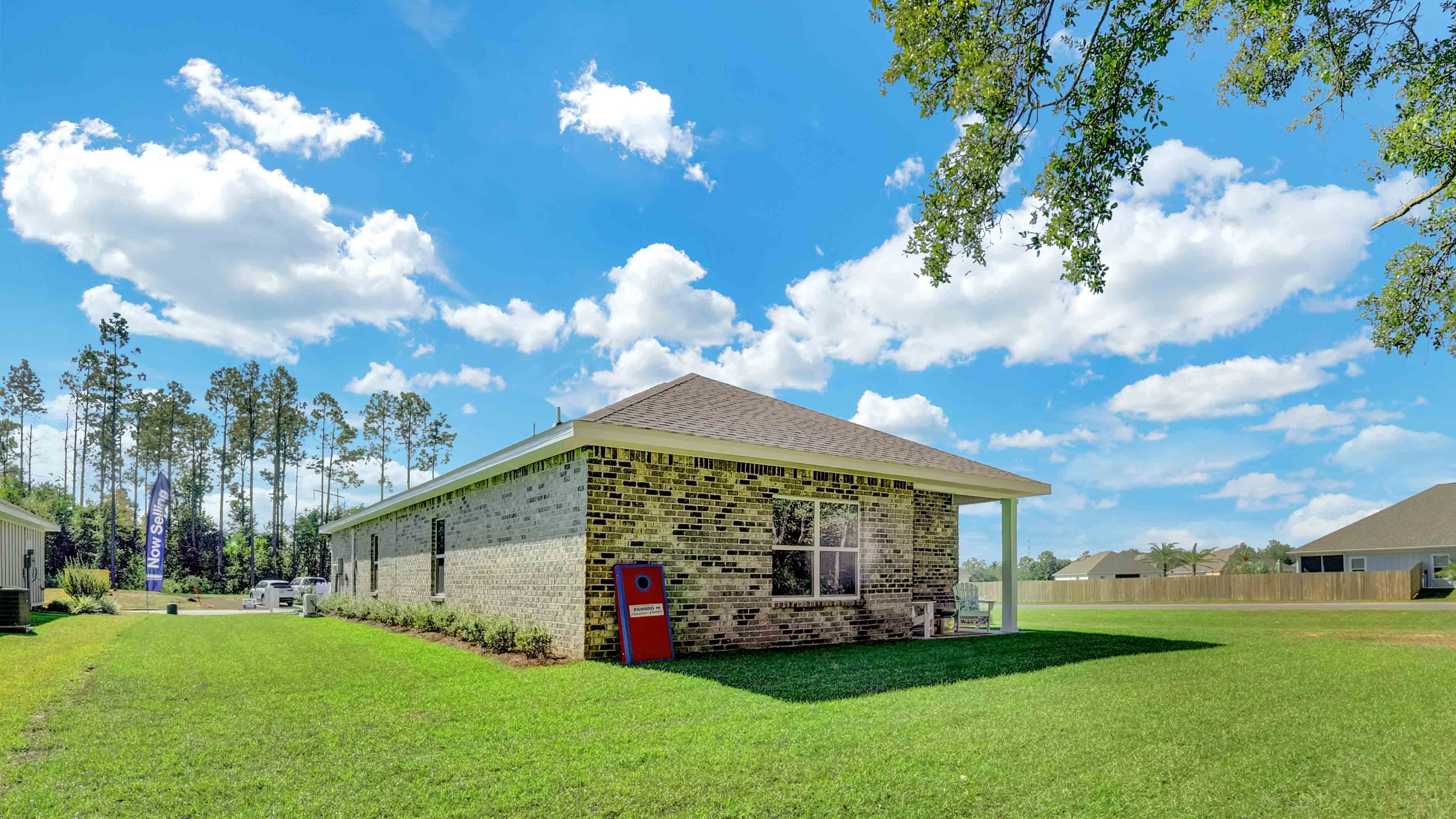 Exterior of brick home with nice yard.