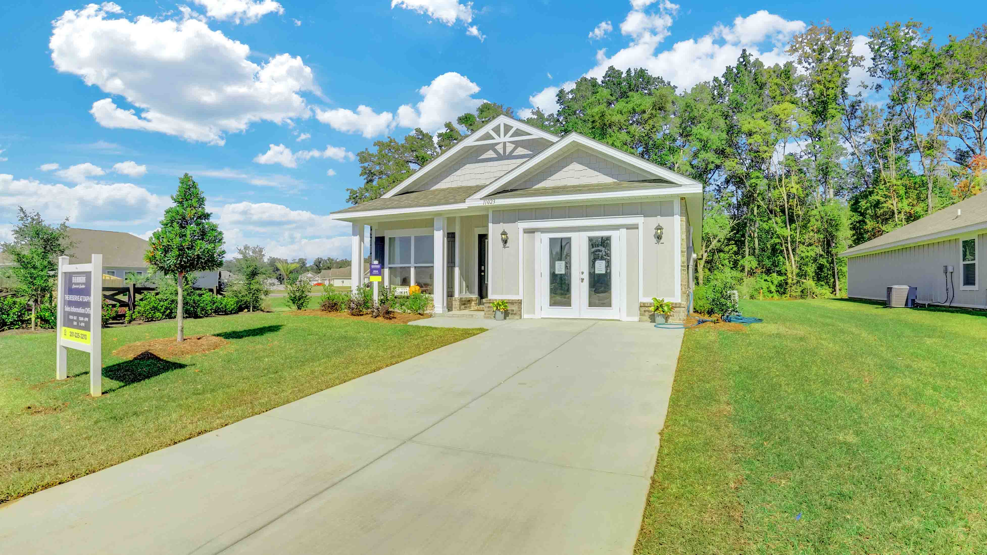 Exterior of model home with nice green yard.