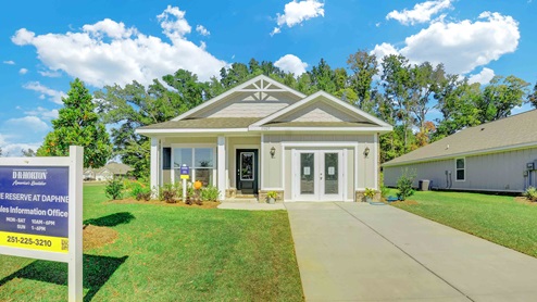 New home exterior with green yard.