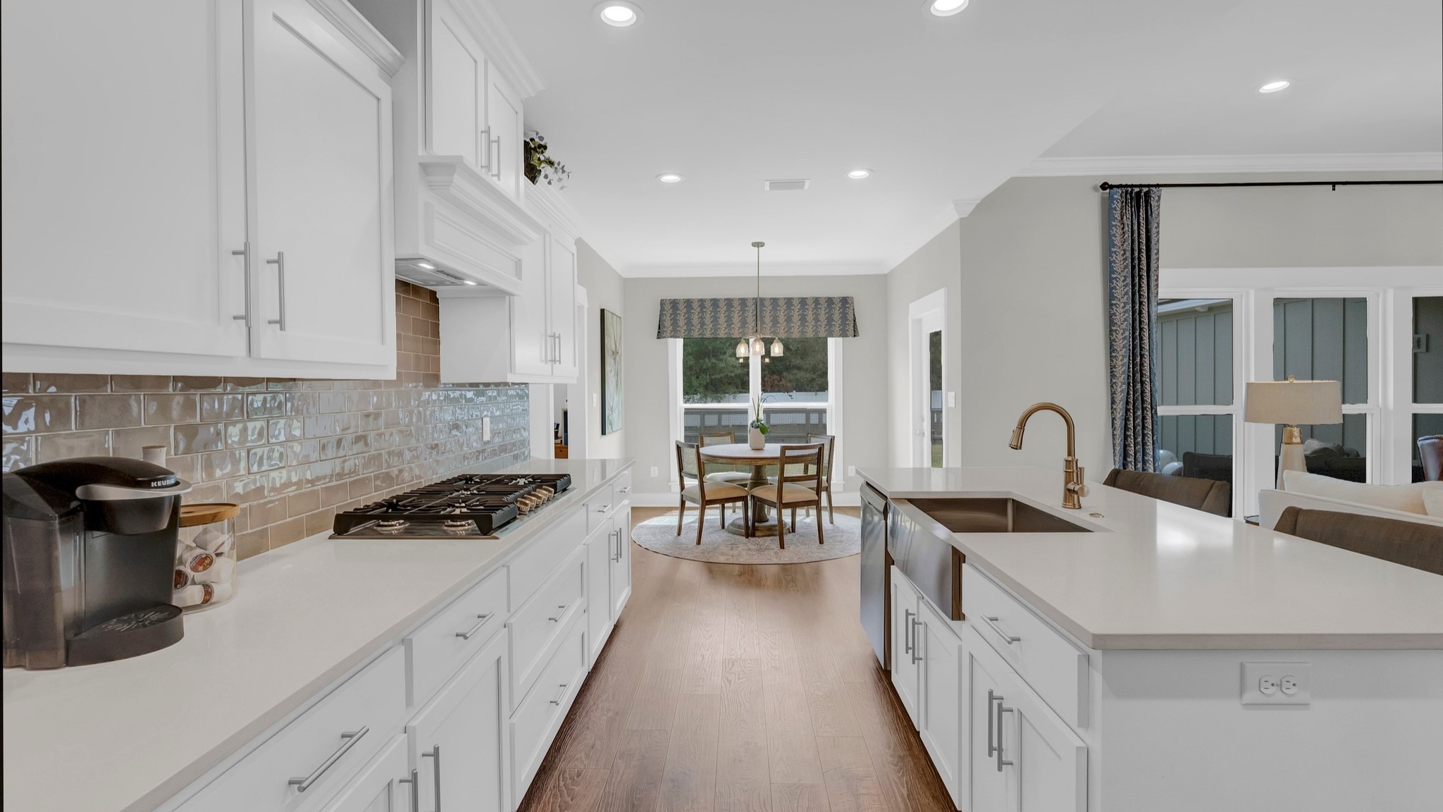 Chef-inspired kitchen with white cabinetry and quartz countertops