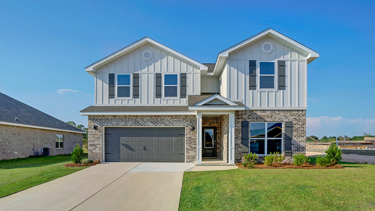 Two-story home with brick and board and batten exterior, a covered front porch, and two-car garage.