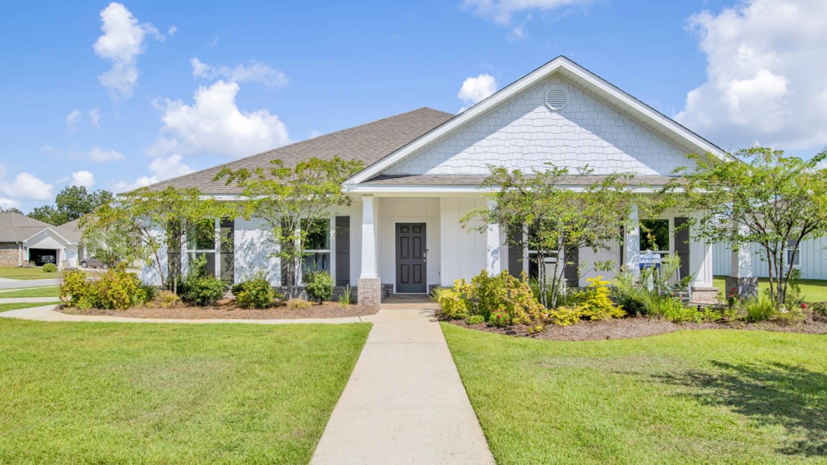 Single-story home with a covered front porch and two-car side entry garage.