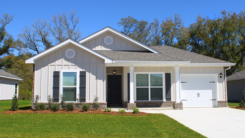 Single-story home with board and batten exterior, a brick water table, craftsman lighting, and a single car garage.