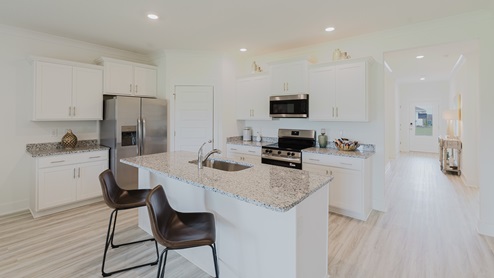 Kitchen with white cabinets and granite countertops