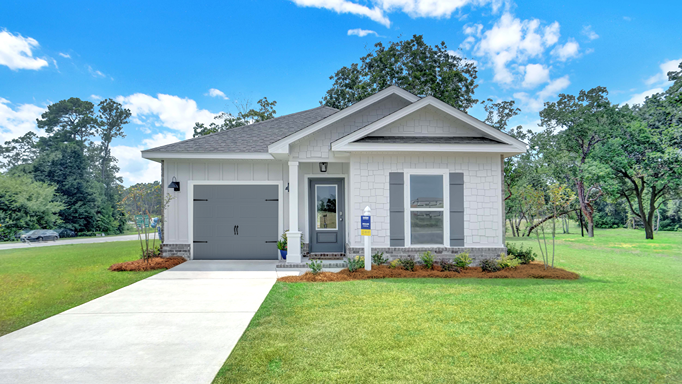 Single-story home with light gray board and batten and shake, a brick water table, covered entry, and one-car garage.