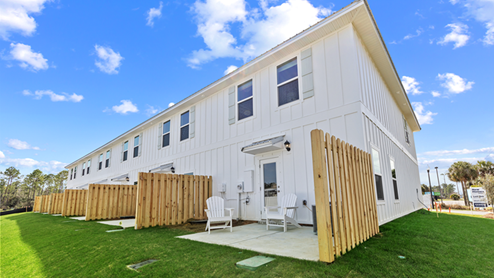 Two-story townhome with board and batten exterior.