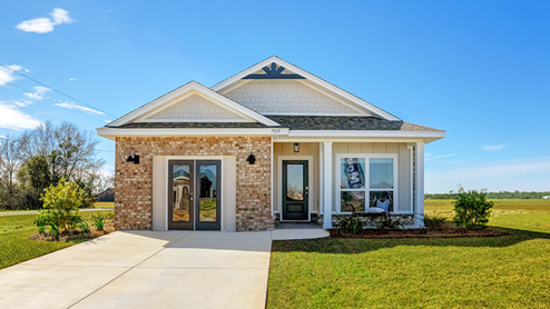 Single-story home with board and batten exterior, brick accents, a covered front porch, and one-car garage.