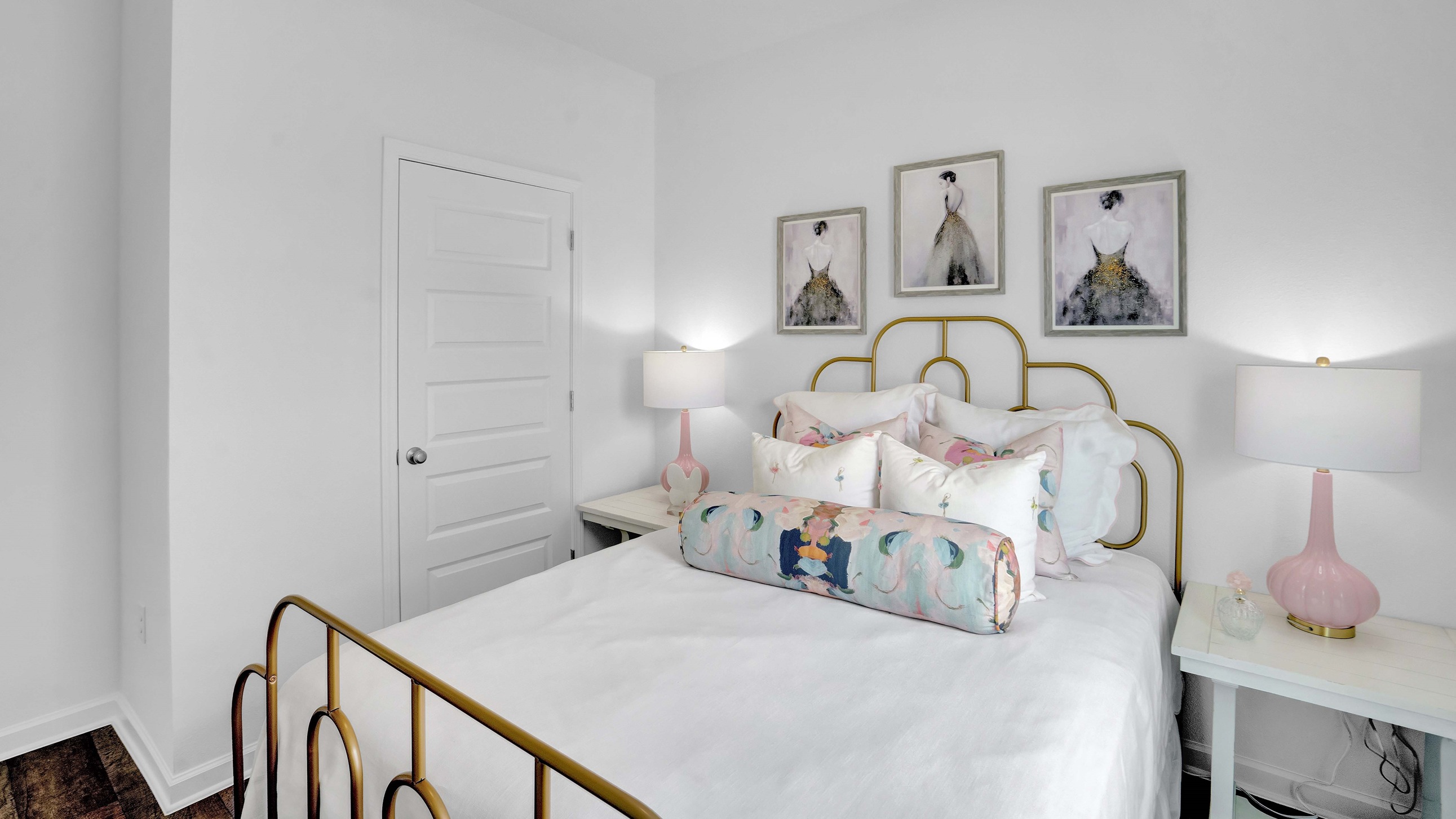 Bedroom set with art on walls.