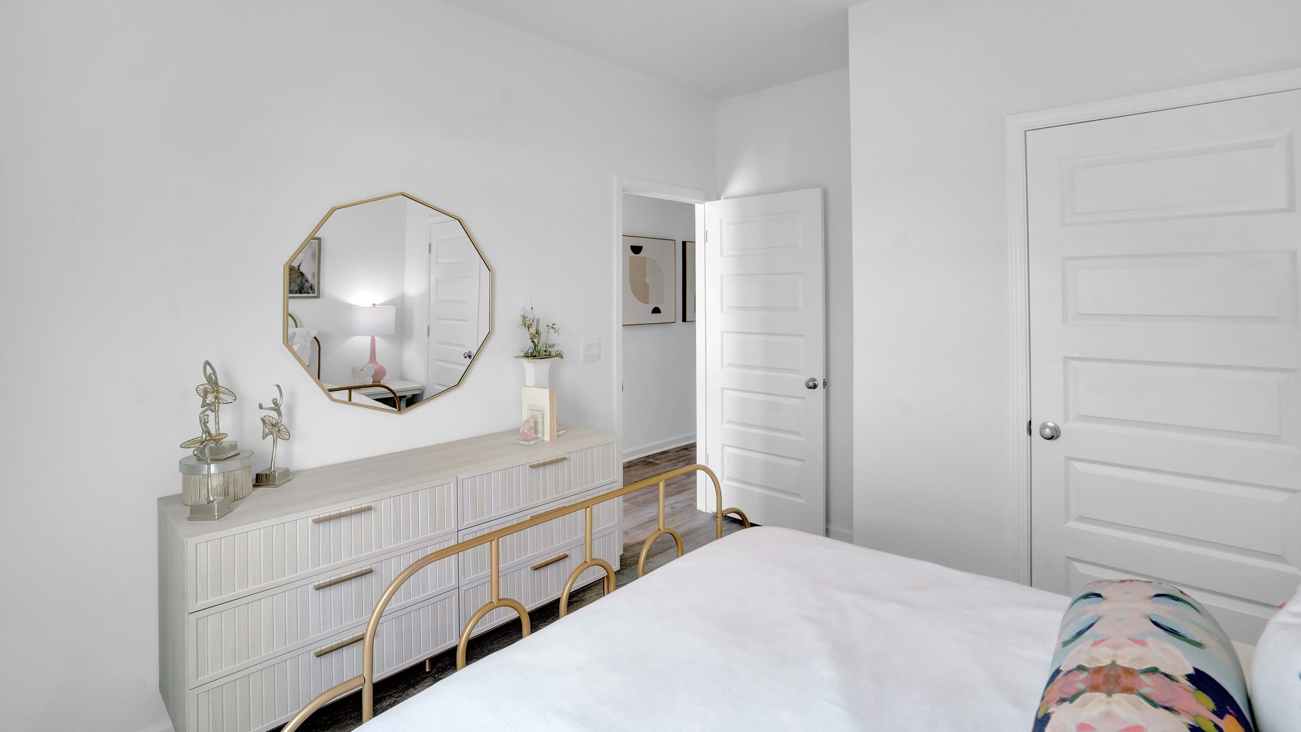 Bed set facing wall with dresser.