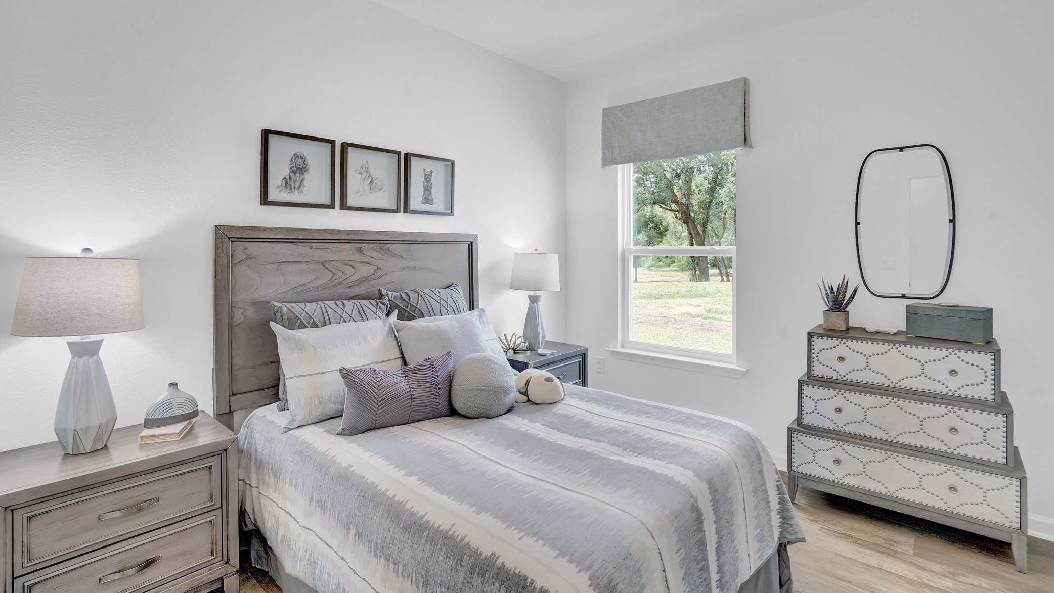 Bedroom set with striped comforter and headboard with lamps and windows adjacent.