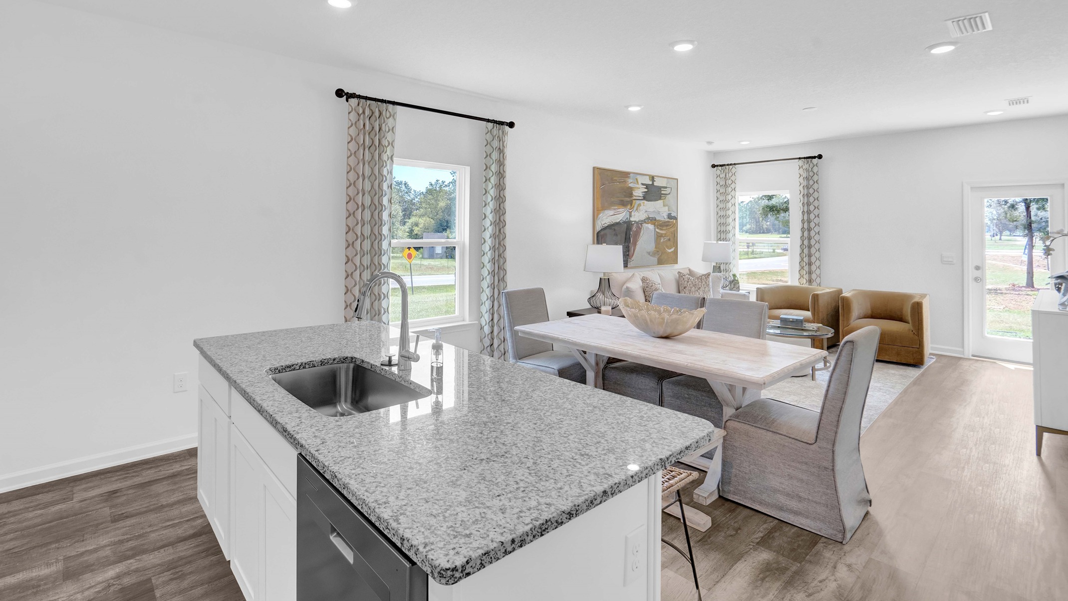 Kitchen island with sink opens into the living area.