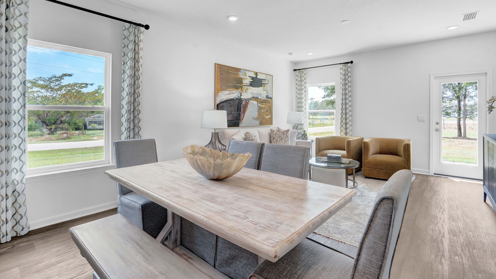 The living area has large windows with light shining through.