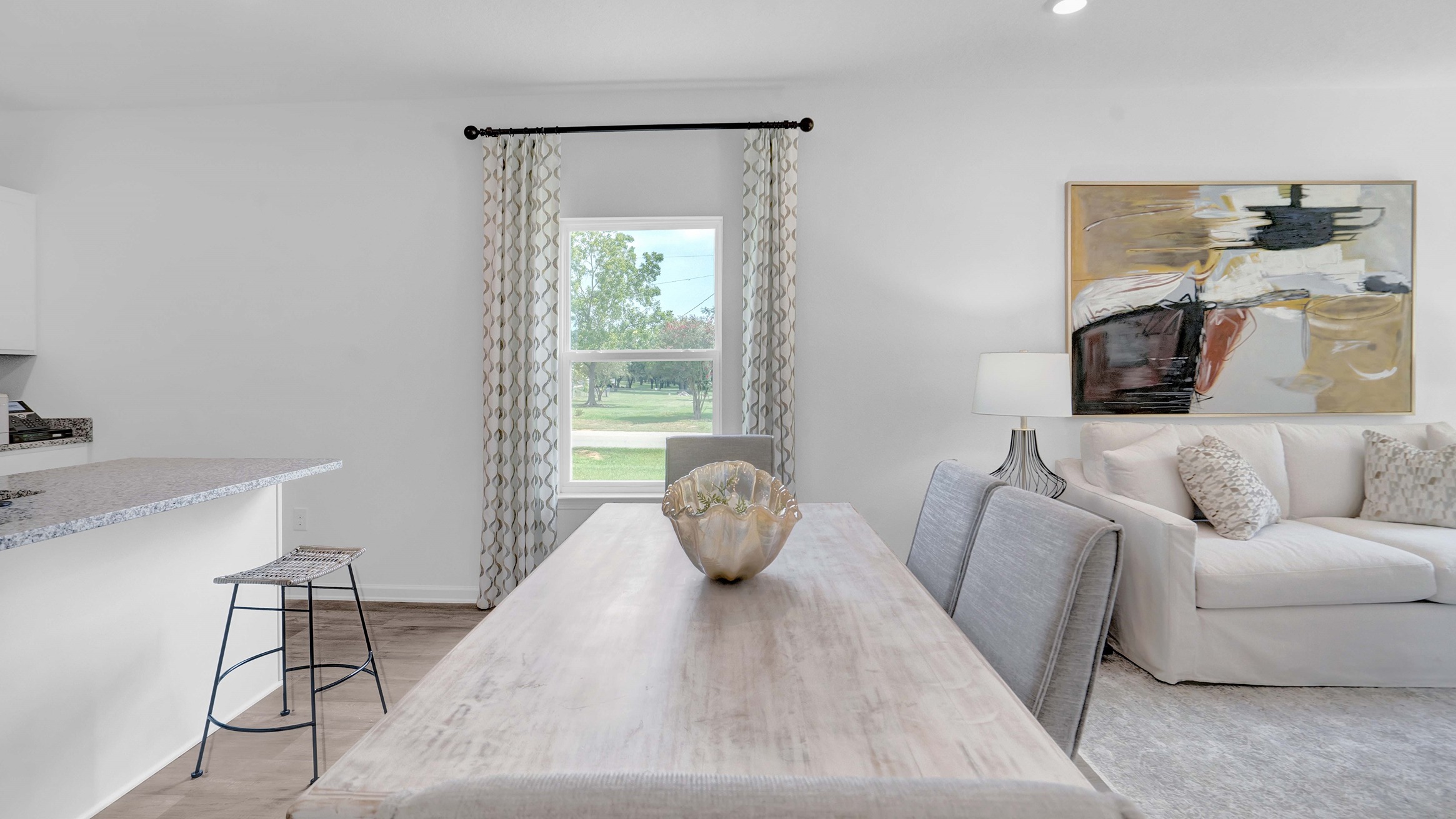 The dining area is flanked by the kitchen and living room.