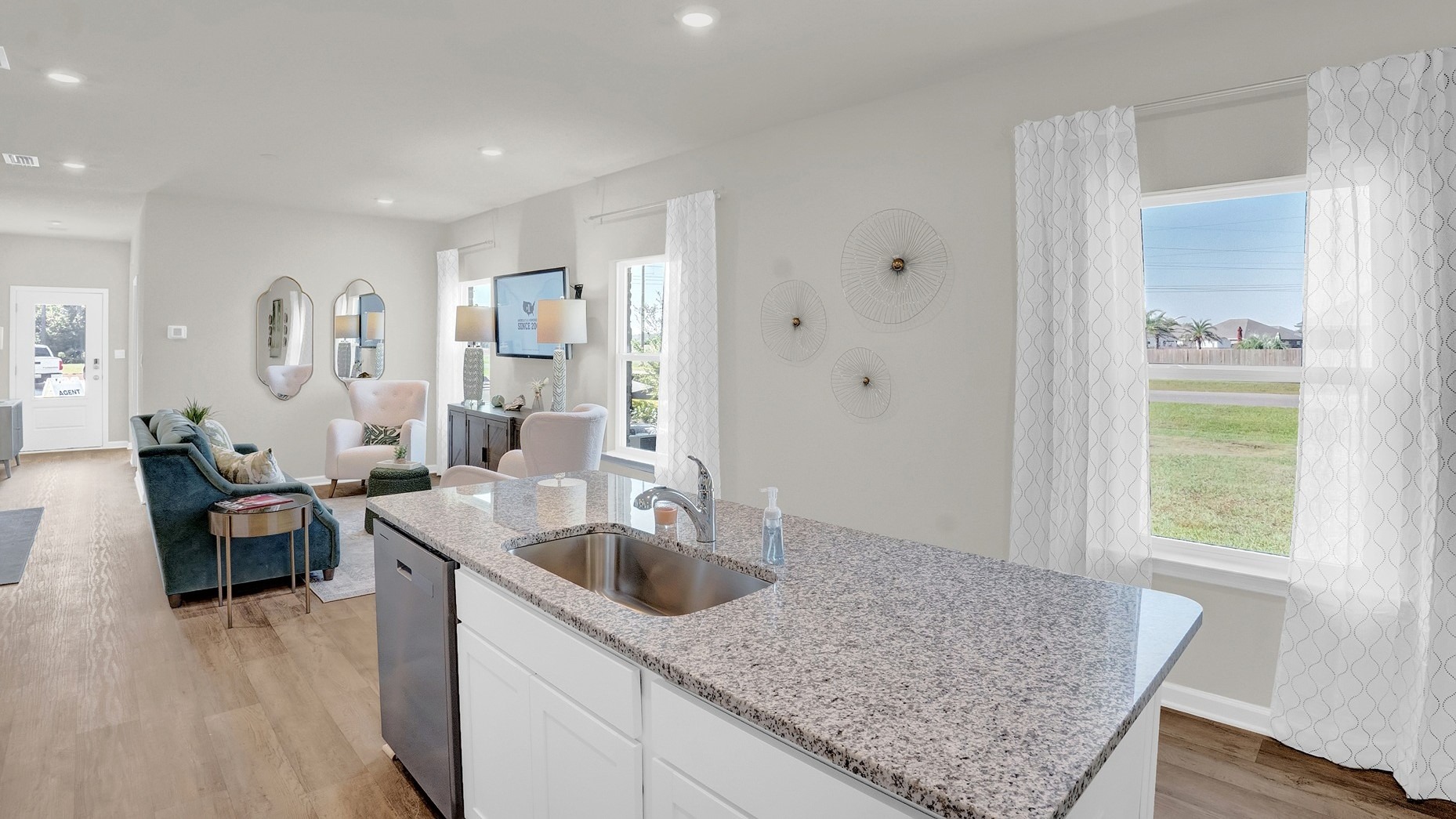 Kitchen island with sink looking out through the windows.