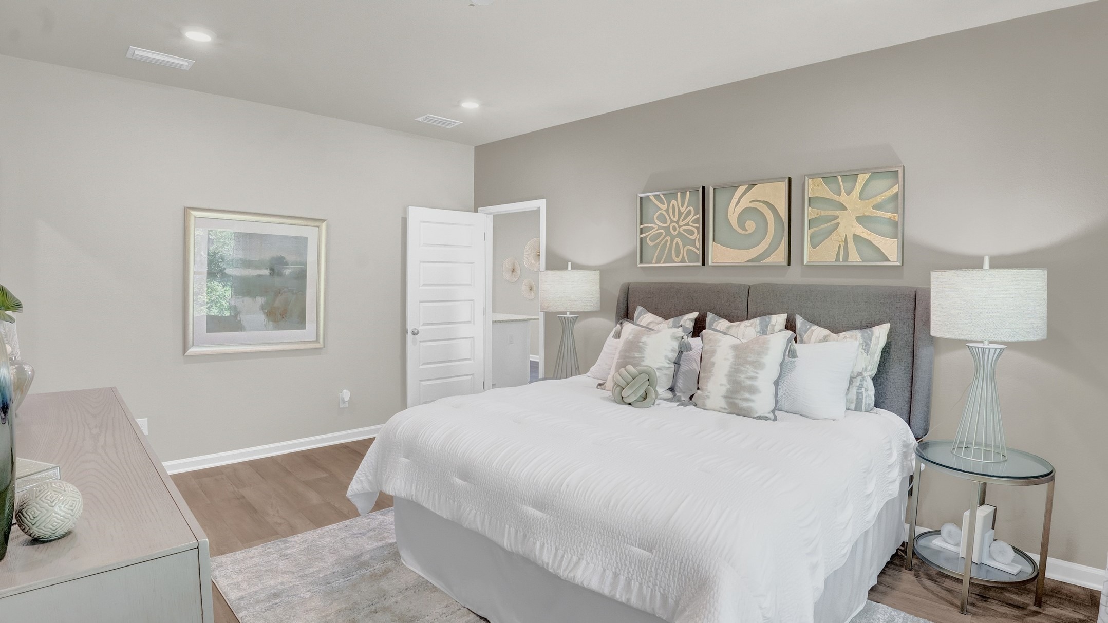 Bedroom showing a full bedroom suite with art on the walls.