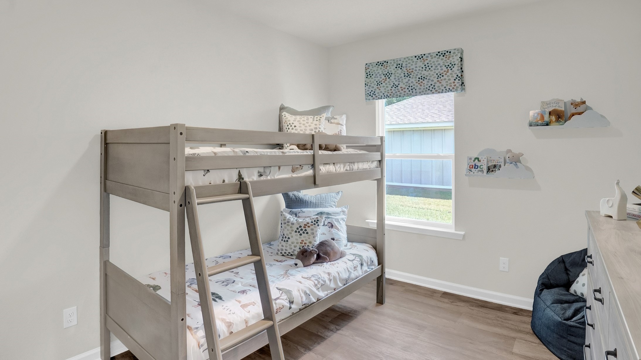 Bedroom with bunkbed and windows.