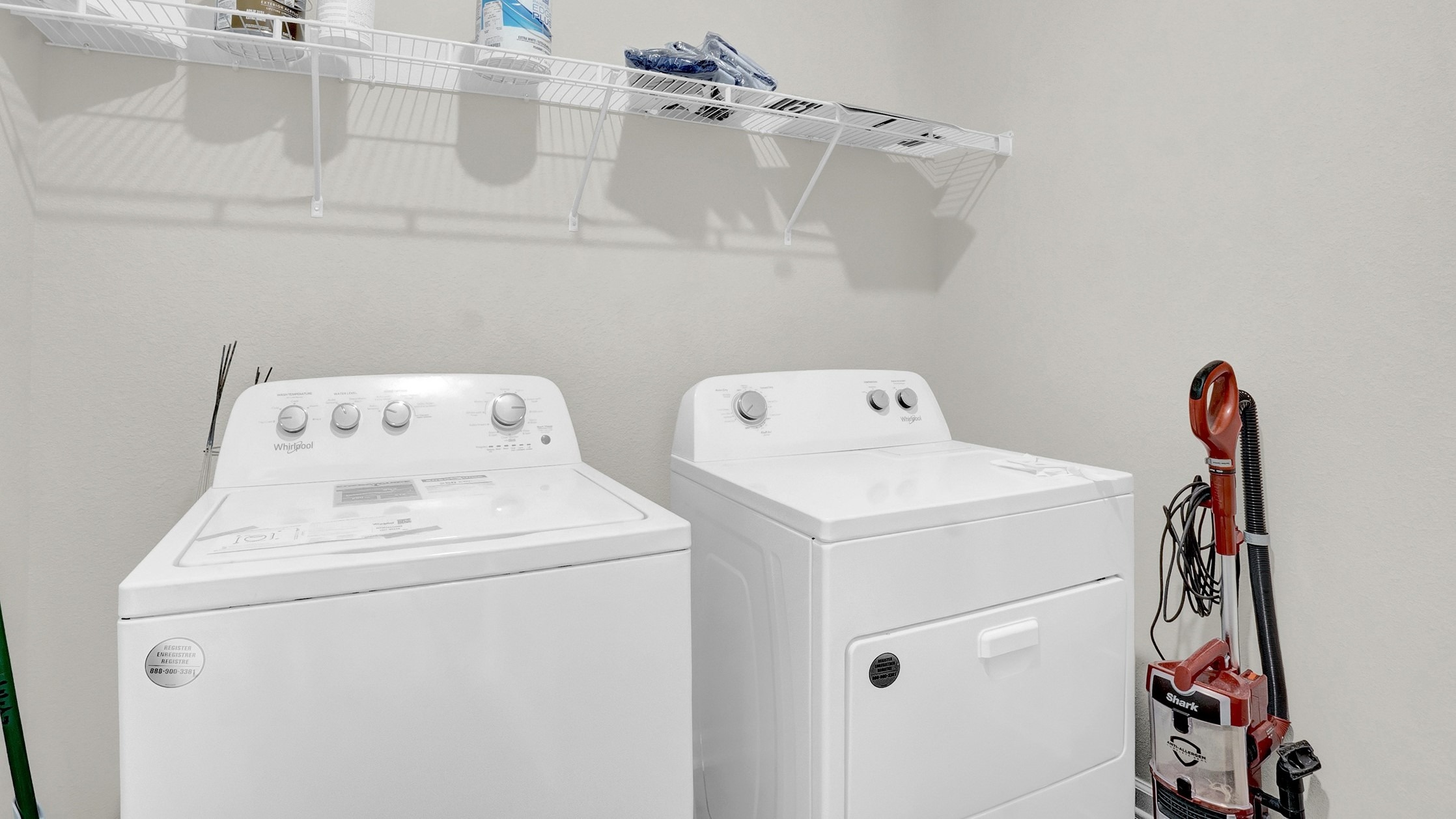 Laundry area is large enough for both washer and dryer and shelving.