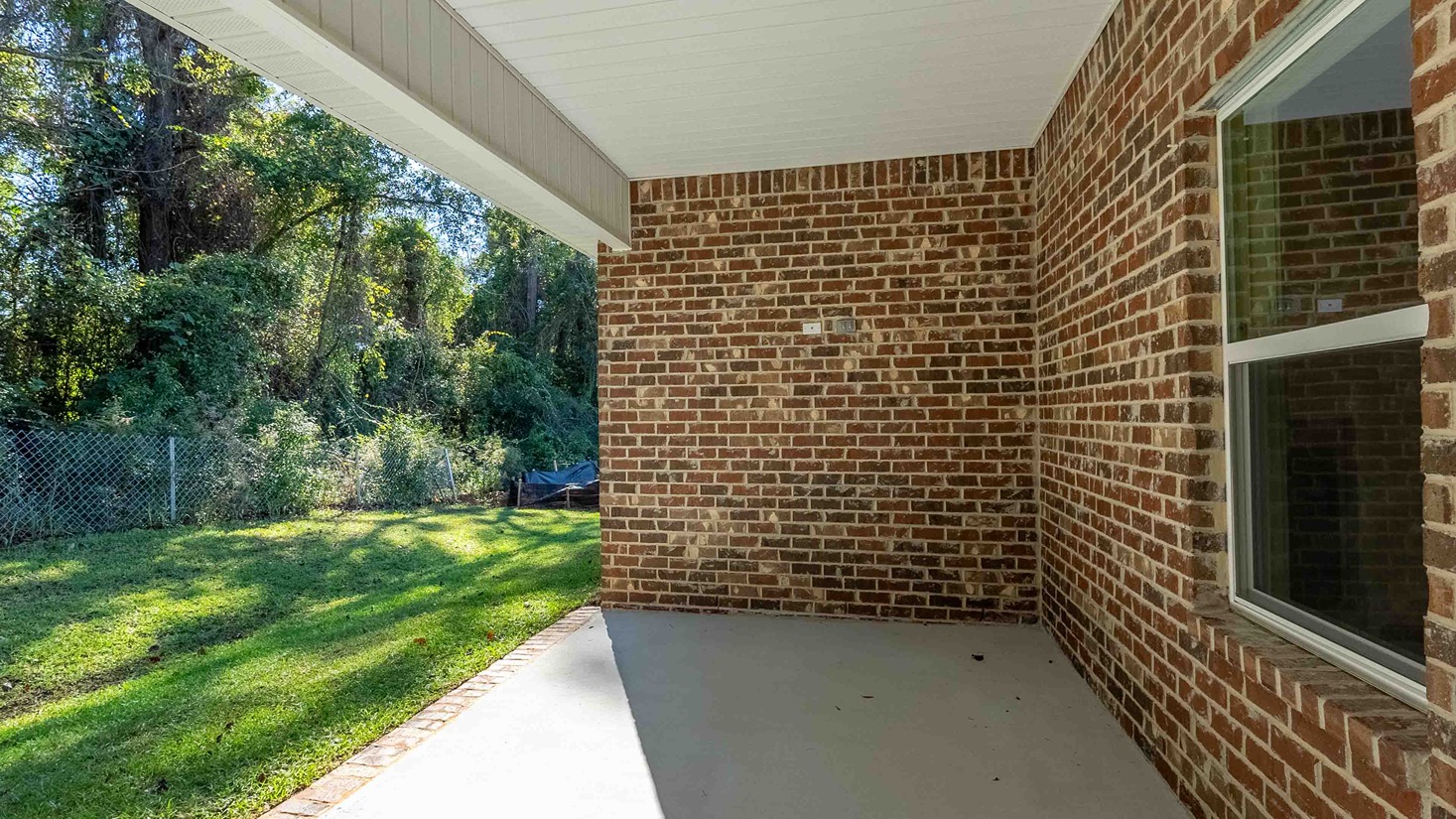 Avery covered back porch with brick exteriors