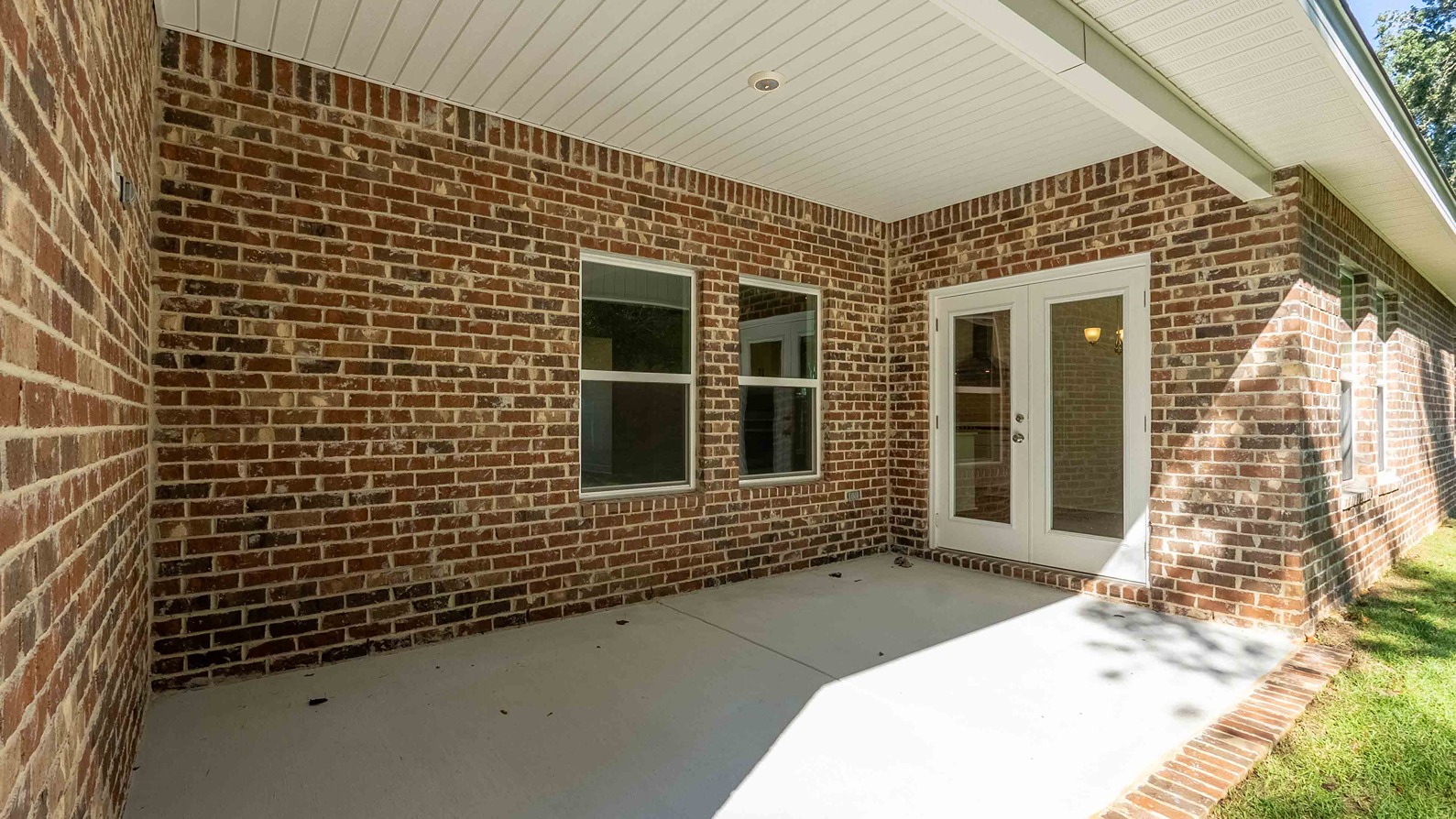 Avery covered back porch with brick exteriors