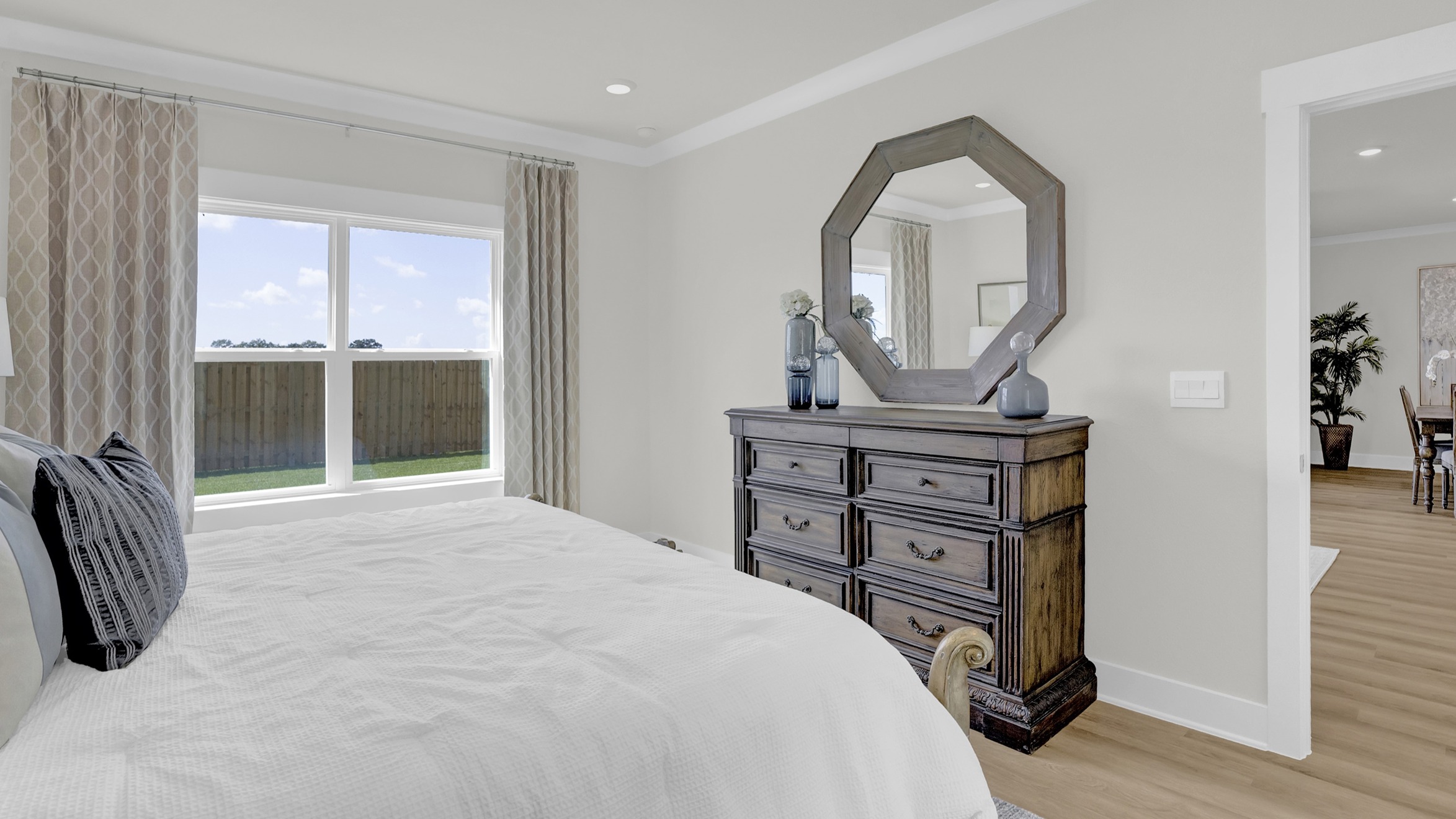 Spacious primary bedroom with large windows.