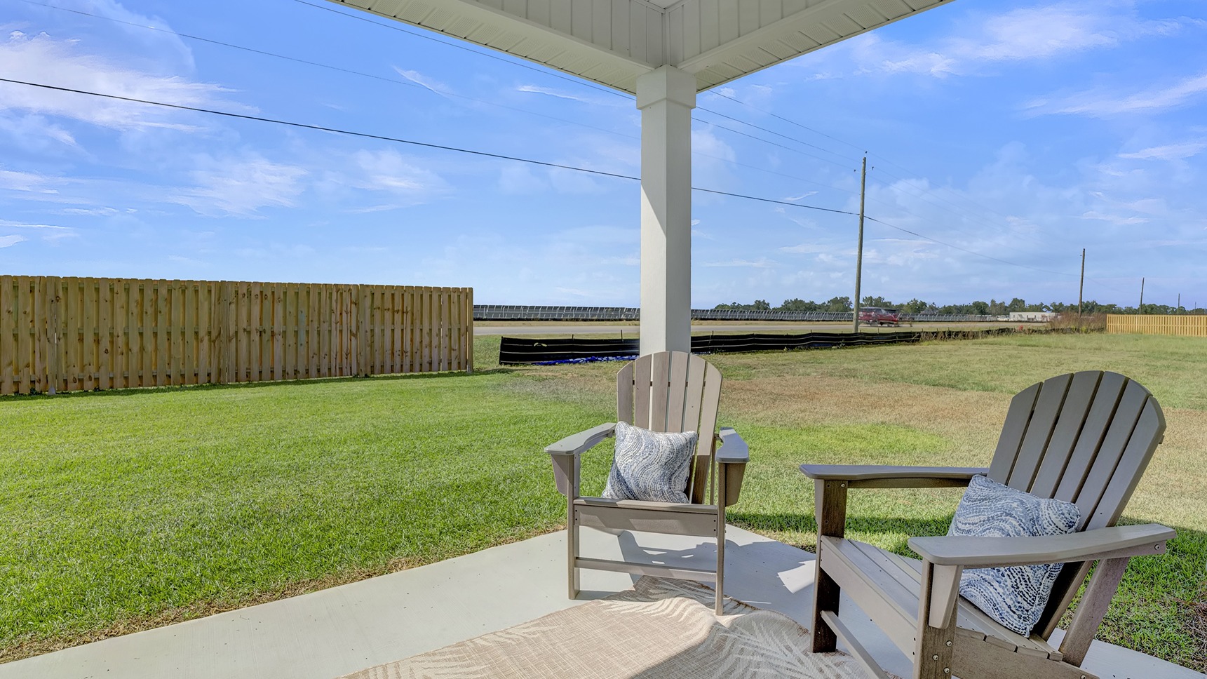 Covered back porch overlooking spacious yard.