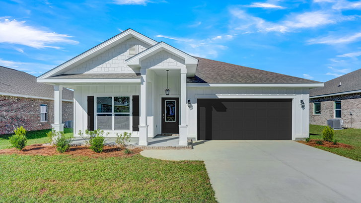 Single-story home with board and batten exterior, a covered front porch, and two-car garage.