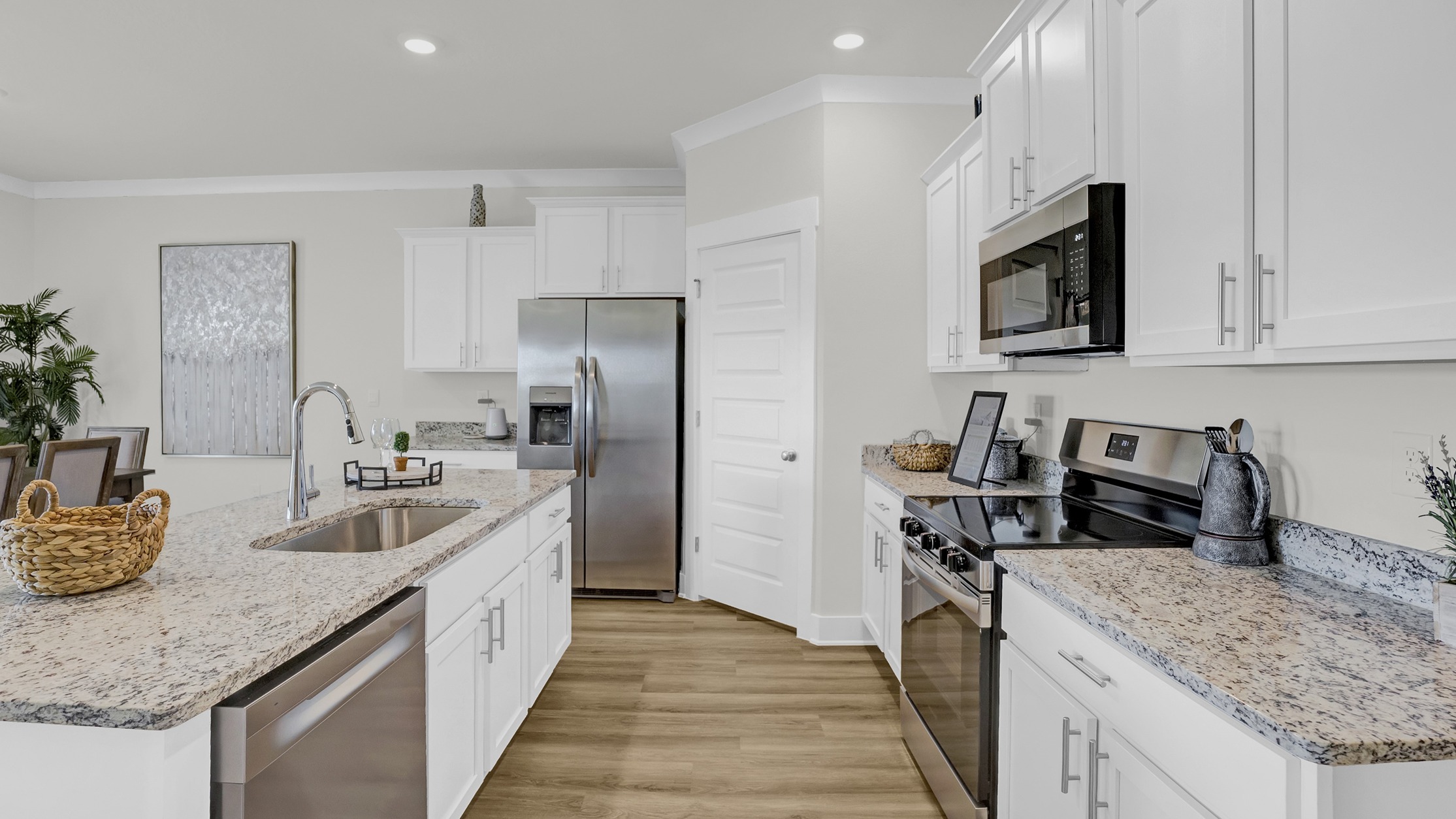 Chef-inspired kitchen with marble countertops, a corner pantry, central island, and stainless-steel appliances.