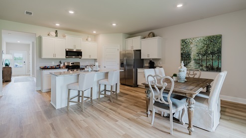 Open-concept interior of kitchen and dining area.