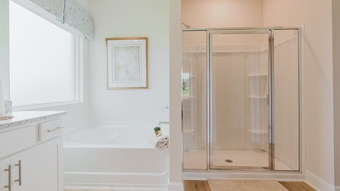 Open-concept interior of primary bathroom.