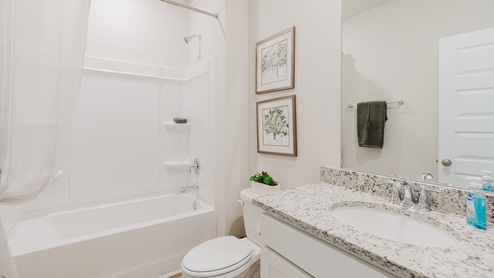 Open-concept interior of second bathroom.