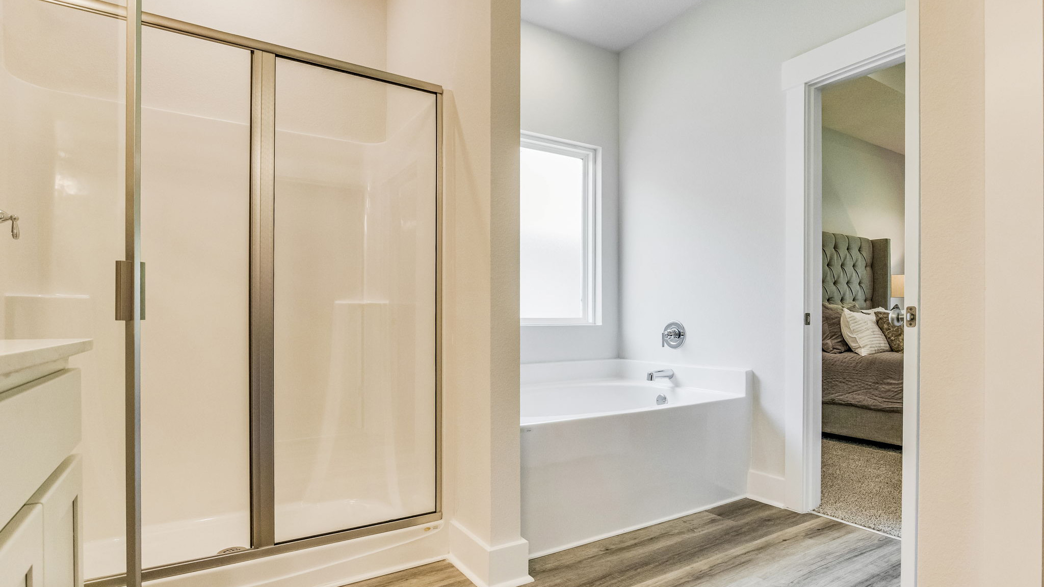 Spacious primary Rhett bathroom with a garden soaking tub and separate shower.