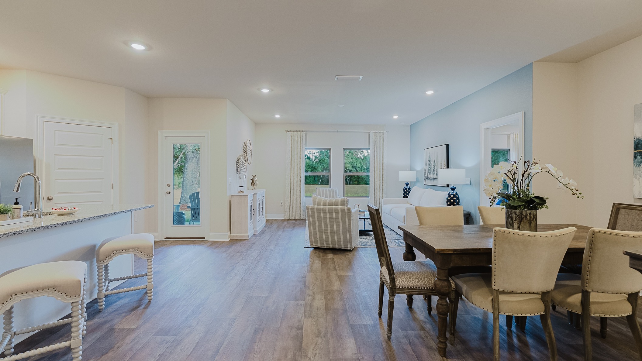 Open concept great room connecting the kitchen, dining area, and living room together.