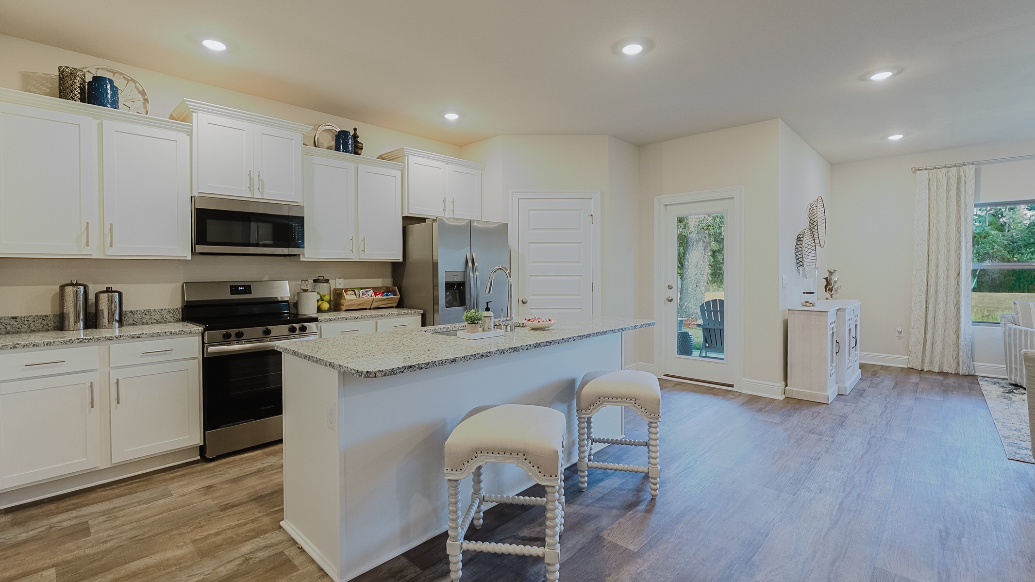 Open concept kitchen with 9-foot ceilings and granite countertops.