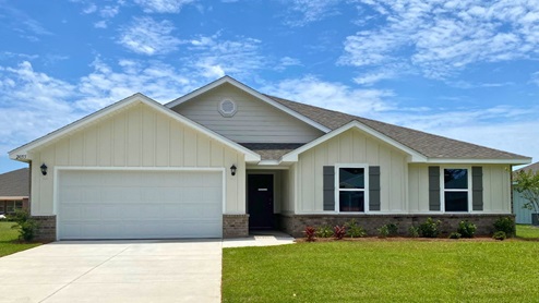 Single story home with siding and brick watertable.