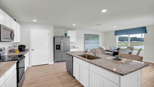 Beautiful open-concept kitchen with white cabinets.