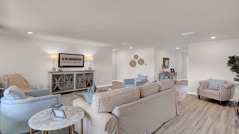 Open concept living room with light wood floors.