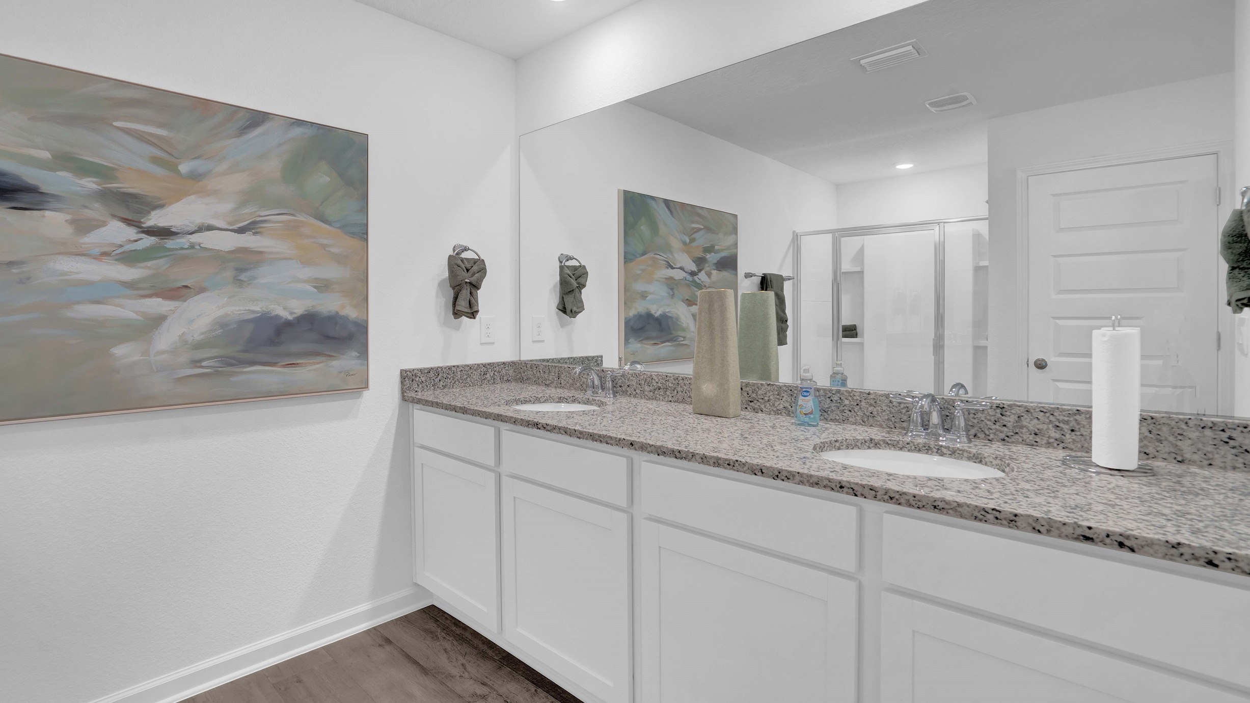 Ryder floorplan primary bathroom with granite countertops and dual sink vanities.