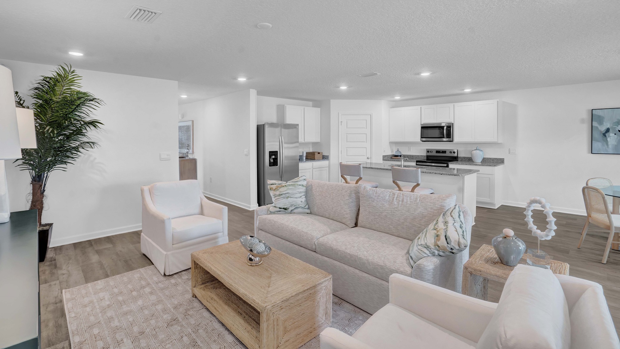 Open concept Ryder floorplan great room connecting kitchen, dining, and living spaces.