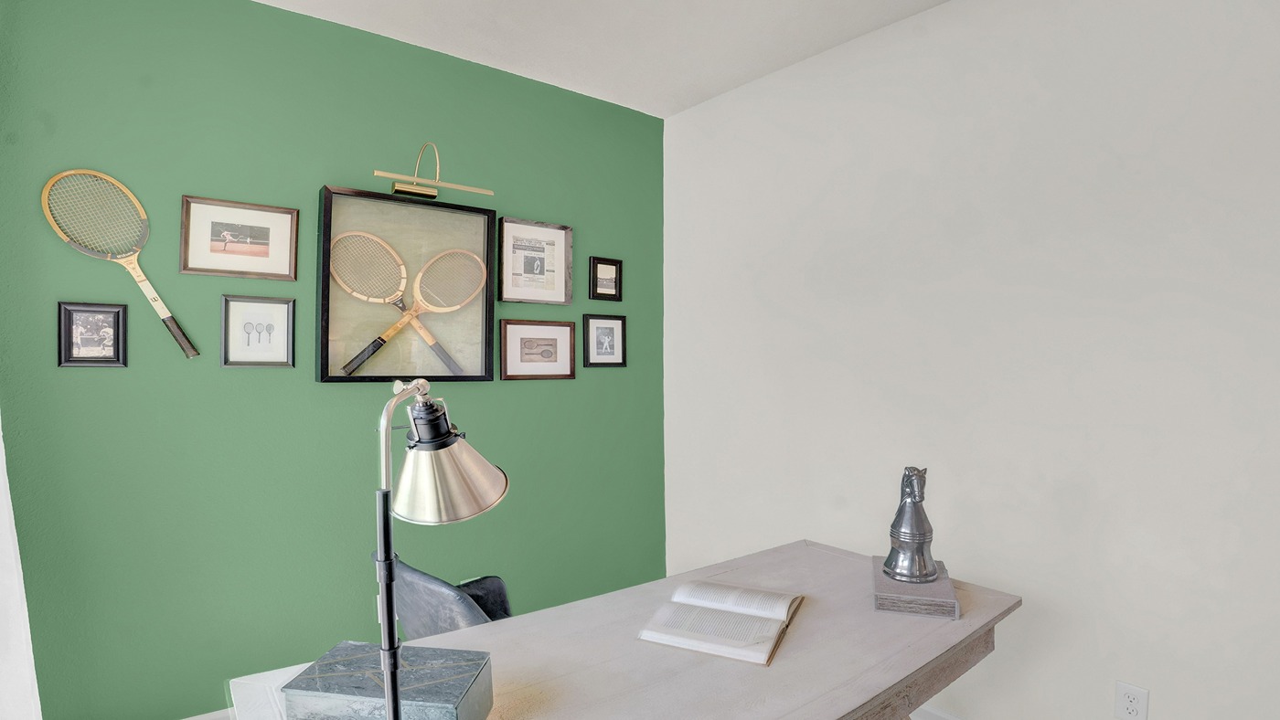 Office area with green walls and desk