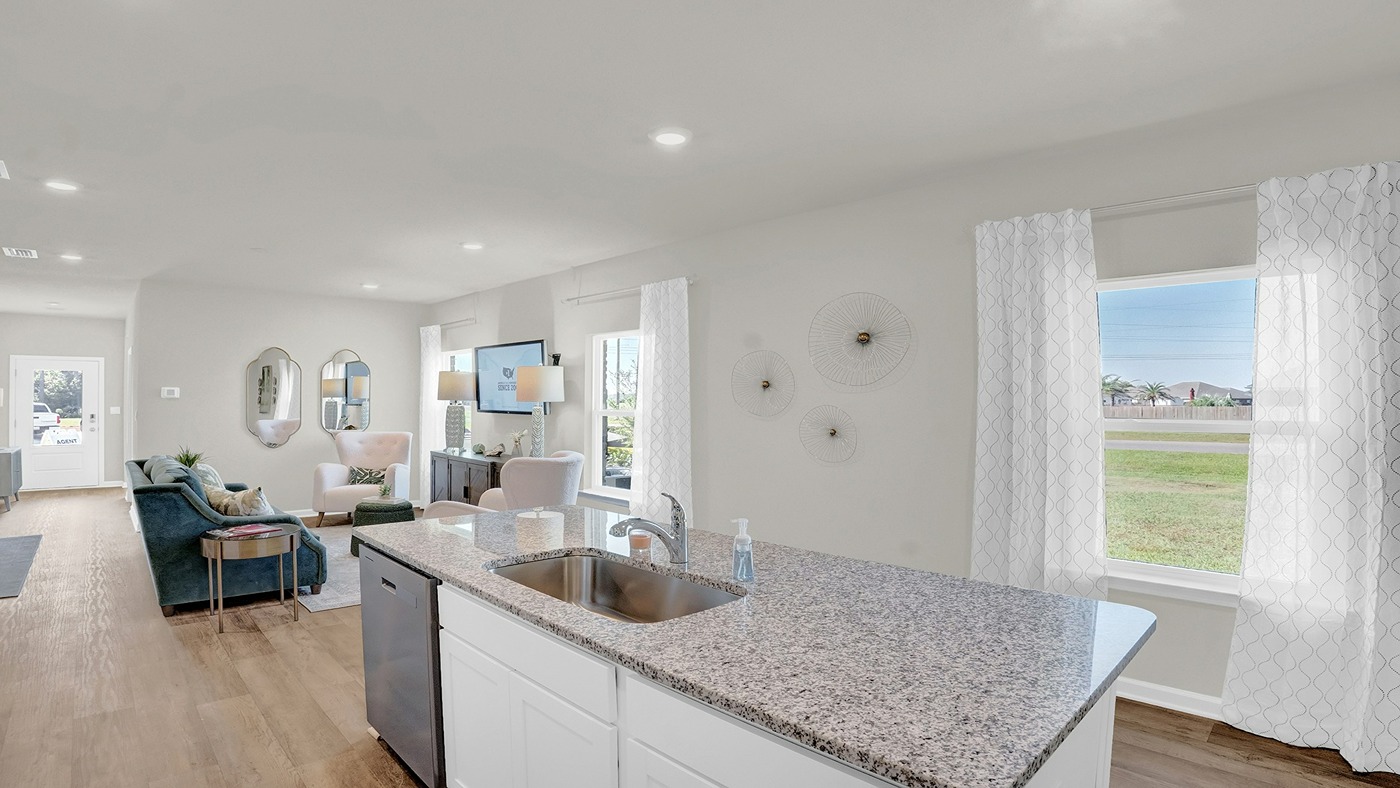 Kitchen island with sink looking out through the windows.